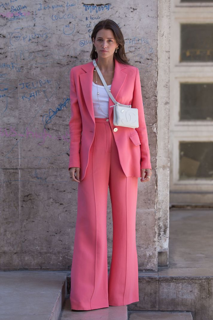 Guest in a tailored pink suit photographed on the street at New York Fashion Week